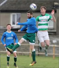  ??  ?? Joe Hyland of Enniscorth­y Town gets his head to the ball ahead of John O’Connor of Shamrock Rovers.