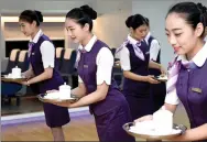  ?? HUANG ZONGZHI/XINHUA ?? Hangzhou-based high-speed train attendants receive training on serving etiquette in the run-up to the G20 summit.