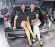  ?? ?? ATL Tiger Motors sales executives Tanisha Summerbell (left) and Samantha Mcgregor show off the extra space that the larger Kia Sportage has.