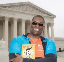  ?? J. SCOTT APPLEWHITE/AP ?? Bryant Johnson, personal trainer for Supreme Court Justice Ruth Bader Ginsburg poses in Washington, with his new book, The RBG Workout: How She
Stays Strong ... and You Can Too! Besides the 84-year-old Ginsberg, Johnson, who now also trains Justice...