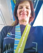  ??  ?? Jackie Jenner proudly displays the medal she received for finishing the Brighton Marathon