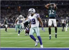  ?? ROGER STEINMAN — THE ASSOCIATED PRESS ?? Dallas Cowboys wide receiver Amari Cooper (19) scores a 15-yard touchdown against the Eagles in overtime on Sunday. Dallas won 29-23.