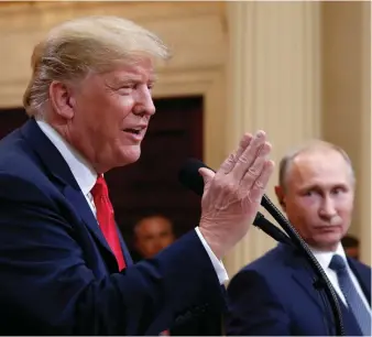  ?? Associated Press ?? ■ President Donald Trump speaks with Russian President Vladimir Putin during a press conference Monday after their meeting at the Presidenti­al Palace in Helsinki, Finland.