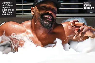  ?? PICTURE: KEVIN QUIGLEY ?? Lighting it up: Chisora enjoys a cigar ahead of his fight with Fury