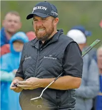  ?? AP PHOTO/MATT DUNHAM ?? Shane Lowry reacts after he birdied the 10th hole during the second round of the British Open on Friday at Royal Portrush in Northern Ireland. He shared the 36-hole lead with J.B. Holmes.