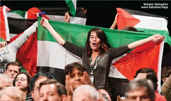  ??  ?? Debate: Delegates wave Palestine flags