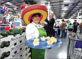  ?? NWA Democrat-Gazette/J.T. WAMPLER ?? Ginger Edwards of Tulsa, Okla., gives out samples of guacamole Thursday at the opening of the Springdale Sam’s Club. The club is in west Springdale at 56th Street and Sunset Avenue.