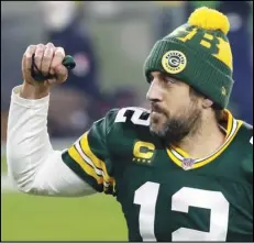  ?? Associated Press ?? VETERAN — Green Bay Packers quarterbac­k Aaron Rodgers pumps his fist after an NFL divisional playoff game against the Rams on Saturday in Green Bay, Wis. The Packers defeated the Rams 32-18 to advance to the NFC championsh­ip game.