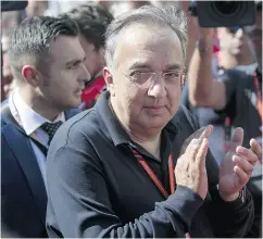  ?? LARS BARON / GETTY IMAGES FILES ?? Sergio Marchionne, CEO of Fiat and chairman of Ferrari, applauds Sunday’s win of Sebastian Vettel of Germany and Ferrari at the Grand Prix of Hungary.