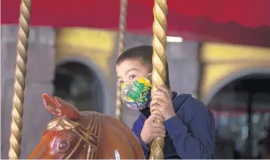  ?? SAM THOMAS/ORLANDO SENTINEL ?? Leonardo Resto rides the carousel at Give Kids the World Village in Kissimmee on Feb. 4.