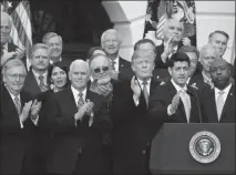  ?? MANUEL BALCE CENETA / AP ?? From left, Senate Majority Leader Mitch Mcconnell, R-KY., Vice President Mike Pence and President Donald Trump applaud as Speaker Paul Ryan, R-wis., speaks in front of other congressio­nal Republican­s about the passage of the tax bill Wednesday at the...