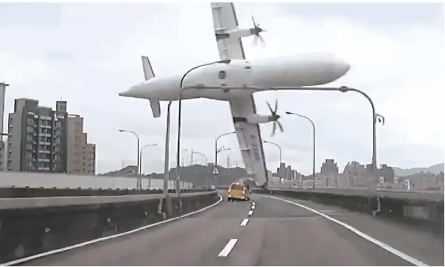  ?? TVBS Taiwan / AFP / Getty Images ?? A TransAsia turboprop plane clipped a bridge before hitting a taxi and crashing into the Keelung river outside Taipei in Taiwan on Wednesday. At least 15 of the 58 passengers on board were rescued, below, while others are thought to have survived the...