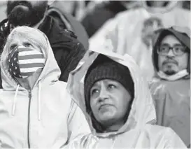  ?? TED S. WARREN/AP ?? Fans attend a profession­al soccer match Feb. 27 in Seattle. A new poll shows Americans are relaxing how often they’re wearing masks to protect against COVID-19.