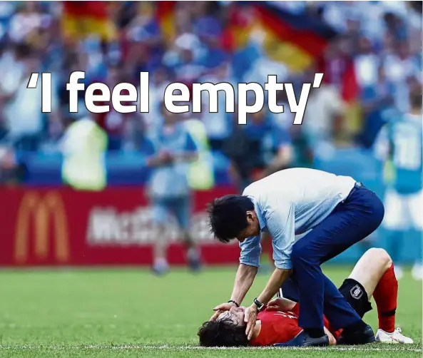  ??  ?? Big boys don’t cry: South Korea coach Shin Tae-yong (right) consoling midfielder Lee Jae-sung following their Group F win over Germany at the Kazan Arena on Wednesday. —AFP