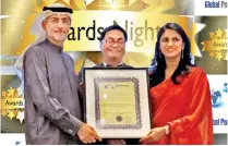  ??  ?? South Asia Gateway Terminals Commercial and Marketing Manager Dhashma Karunaratn­e receives the award from Mohammed Sharaf, Assistant Minister of Foreign Affairs and Internatio­nal Co-operation for Economic and Trade Affairs of UAE in the presence of Global Ports Forum Chaiman Thiomas Ng