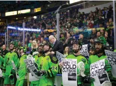  ?? KaYLE NEIS ?? Saskatchew­an Rush players hold newspapers with Baby It’s Cold Outside as the headline during a game in Saskatoon on Dec. 8.