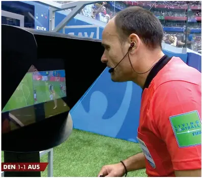  ??  ?? Having another look: Spanish referee Antonio Mateu Lahoz consults VAR and duly awards Australia a penalty in their 1-1 draw with Denmark