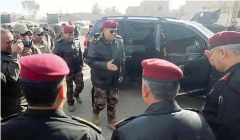  ?? — AFP ?? Iraqi Staff General Talib al Shaghati (C) arrives in the town of Bartella, east of Mosul, for a press conference on Wednesday.