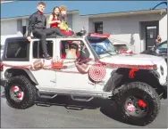  ?? Westside Eagle Observer/SUSAN HOLLAND ?? Homecoming queen candidate Dannia Morales, with her escorts junior Clayton Nall and sophomore Kelton McDougal, rides in the 2022 homecoming parade. Morales was crowned homecoming queen that evening in ceremonies at Lion Field.