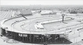  ?? STEVE HELBER THE ASSOCIATED PRESS ?? An aerial view of Richmond Raceway as workers put finishing touches on changes to the infield in Richmond, Va. The infield was torn apart after last September's race with a new garage and pedestrian tunnel added.