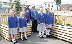  ??  ?? Pictured are Fairfield Preparator­y School pupils in the garden with the raised flower beds.