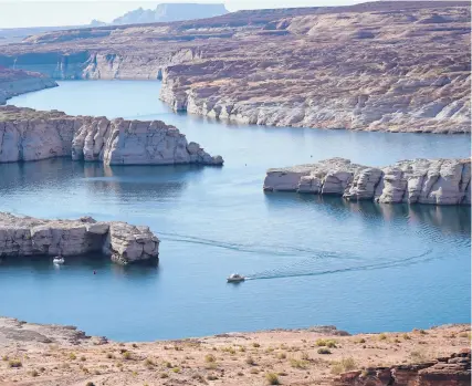  ?? RICK BOWMER/AP 2021 ?? The elevation of Lake Powell, above, fell below a critical threshold Tuesday. The drop marks another realizatio­n of the effects of climate change and megadrough­t.