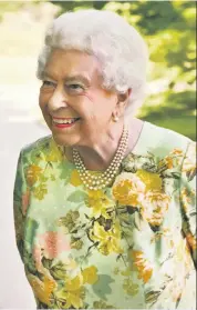  ??  ?? All smiles: the Queen in the gardens of Buckingham Palace