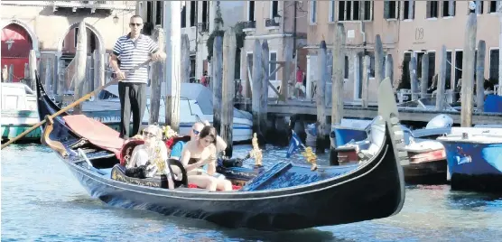  ?? PHOTOS: KEVIN BISSETT/ THE CANADIAN PRESS ?? Tourists explore the canals of Venice, Italy. Leave the planning to a motor coach company and focus on taking in the sights.