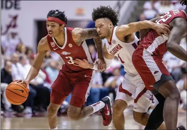  ?? Associated Press ?? Driving hard: Arkansas guard Nick Smith Jr. (3) works past Alabama guard Mark Sears (1) during the first half of Saturday in Tuscaloosa, Ala.