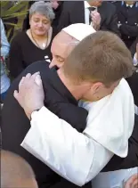  ?? Associated Press ?? Pope Francis hugs an inmate at the Paliano detention center, south of Rome, on Thursday.