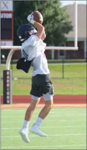  ??  ?? Conway Christian’s John Michael Scherrey makes a leaping catch during practice.