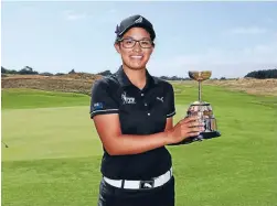  ?? Photo: SIMON WATTS/WWW.BWMEDIA.CO.NZ ?? Winning ways: Julianne Alvarez poses with the strokeplay trophy after her convincing win at Paraparaum­u Beach yesterday.