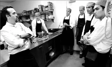  ?? RICK MADONIK/TORONTO STAR ?? Executive chef Mark Marchment, left, gives a last-minute pep talk to the inaugural Oliver & Bonacini kitchen staff.