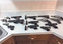  ?? PORT CHESTER POLICE DEPARTMENT VIA THE (WESTCHESTE­R COUNTY) JOURNAL NEWS ?? Guns seized in a raid in Port Chester, N.Y., are displayed in 2014. A report released Tuesday found that 74% of guns used in crimes in New York originated from other states.