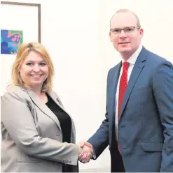  ??  ?? Karen Bradley and Simon Coveney greet each other in London