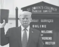  ?? PATRICK SEMANSKY/AP ?? President Donald Trump holds a Bible on June 1 as he stands outside St. John’s Church across Lafayette Park from the White House.