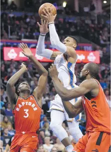  ??  ?? Thunder guard Russell Westbrook flies to the hoop over Raptors O.G. Anunoby, left, and Serge Ibaka.