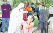  ?? MANOJ DHAKA/HT ?? A health worker collects sample from a woman at the civil hospital in Rohtak on Tuesday.