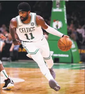  ?? Charles Krupa / Associated Press ?? Boston Celtics guard Kyrie Irving drives to the basket during a preseason game against the Charlotte Hornets on Sept. 30 in Boston.