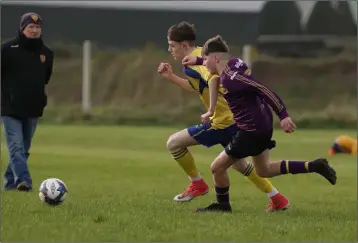  ??  ?? Cillian Twomey of Wexford Albion and Dylan Ryan of Douglas Hall in a race for possession.