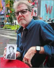  ?? BEBETO MATTHEWS/AP PHOTO ?? This Aug. 7 photo shows Brian Toale, holding a photo of himself at 16 years old in New York. Thousands of people who say they were molested as children in New York state will head to court this week to file lawsuits against their alleged abusers and the institutio­ns where they worked. Toale, 66, who says he was molested by an employee at a Catholic high school he attended on Long Island, was one of the leaders in the fight to pass the Child Victims Act.