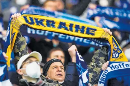  ?? Photo / Getty Images ?? A German football fan holds a scarf in support of Ukraine at a Bundesliga game yesterday.