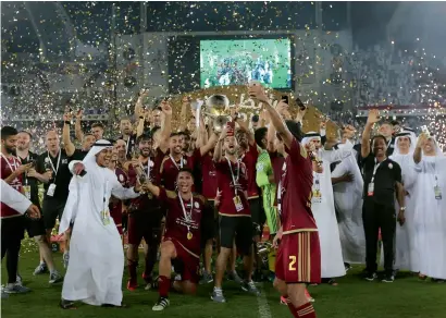  ??  ?? Al Wahda players celebrate after winning the President’s Cup final at Zayed Sports City in Abu Dhabi on Friday.