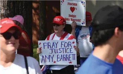  ?? Photograph: Paul Hennessy/Sopa Images/Rex/Shuttersto­ck ?? A woman at a rally in Florida holds a placard in support of Amy Coney Barrett.