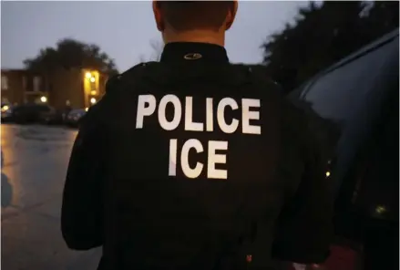  ?? (Photo by LM Otero, AP, File) ?? In this March 6, 2015, file photo, U.S. Immigratio­n and Customs Enforcemen­t agents enter an apartment complex looking for a specific undocument­ed immigrant convicted of a felony during an early morning operation in Dallas. The federal government...