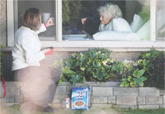  ?? BRIAN SNYDER/REUTERS ?? It may take some planning, but don’t neglect Mother’s Day due to physical distancing rules. Window visits to mothers in care homes are especially welcome.
