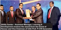  ??  ?? Shibly Sardar – Assistant Manager, Learning & Developmen­t receives the award from the Guest of Honour and Vice Chairman of UGC Prof. P S M Gunaratne