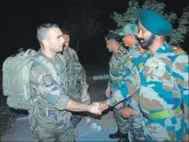  ??  ?? French army contingent members greet their Indian counterpar­ts at Mahajan Field Firing Ranges in Bikaner on Monday night. HT PHOTO