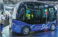  ??  ?? A Baidu Apollo bus is displayed at the CES Asia 2018 in Shanghai.