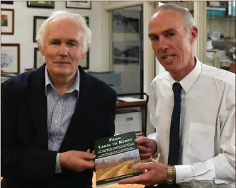  ??  ?? Tarbert native and retired UCC lecturer Dr Michael Christophe­r Keane presents Tommy O’Connor of Kerry County Library with a copy of his new book From Laois to Kerry and, inset, some of the crests brought south to Kerry by the transplant­ed Laois septs.